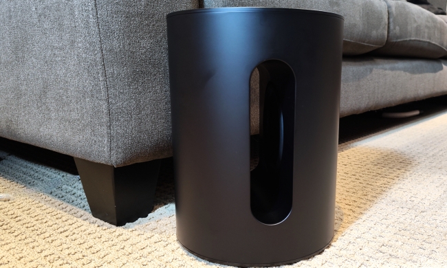 Sonos Sub Mini in front of a sofa.